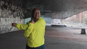a woman in a yellow jacket is stretching video