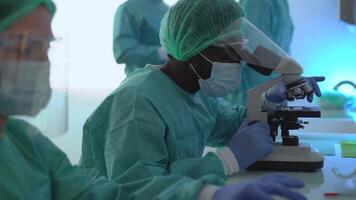 a group of people in protective suits working in a lab video