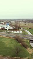 aerial view of highway across a canal beside a town video