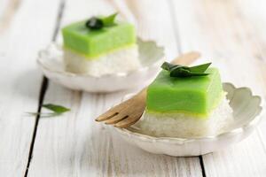 Two Layered Dessert with Steamed Glutinous Rice at the Bottom and Green Custard Layer Cake photo