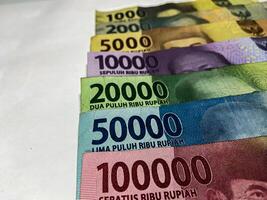 Indonesian Rupiah. Collection of Indonesian rupiah banknotes isolated on white background photo