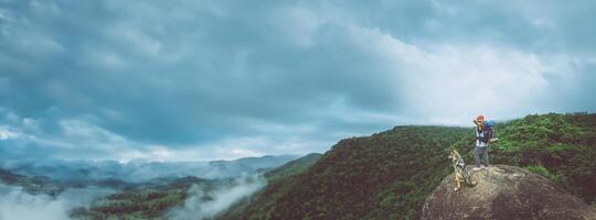 Asian women travel relax in the holiday. Standing on the mountain. on a rocky cliff. Thailand photo