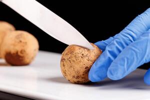 Beautiful candy truffle in a cut on a white plate on a black background photo