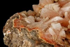 Macro of a stone Stilbite mineral on a black background photo