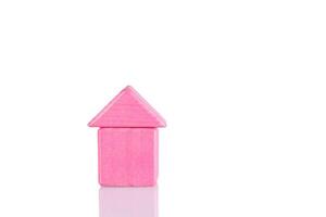 Wooden house of pink color on a white background photo