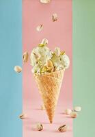 Ice cream with pistachios in a waffle cone on a pink background. Isolated on a pink background. photo