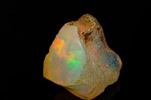 macro mineral stone rare and beautiful opals on a black background photo