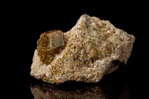 Macro stone Grossular mineral on a black background photo