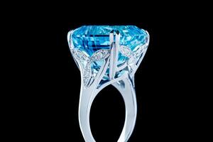 Beautiful gold ring with aquamarine and diamonds on a black background photo