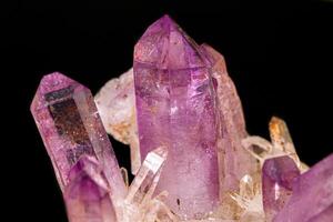 Macro of amethyst mineral stone on black background photo