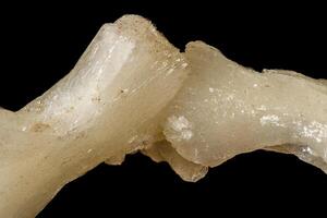 Macro of a stone Stilbite mineral on a black background photo