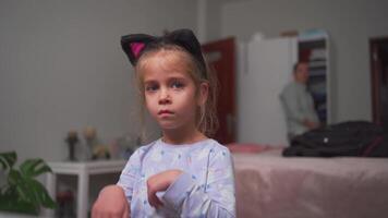 a little girl wearing a cat ears hat video