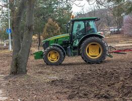 Nitra, Slovakia - 01.16.2024 A tractor harrows the soil in a field. photo