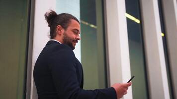 a man in a suit watching his phone on the street video