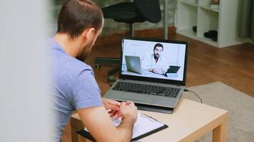 Revealing shot of patient on video call with doctor during covid-19 isolation.