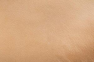 A close-up shot of the texture of vegetable-tanned cattle leather, used as a backdrop. photo