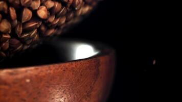 Buckwheat in a wooden bowl. Filmed on a high-speed camera at 1000 fps. High quality FullHD footage video