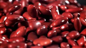 The fall of red beans. Filmed on a high-speed camera at 1000 fps. High quality FullHD footage video