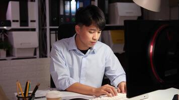 Exhausted Asian young businessman worker working on table in office. video