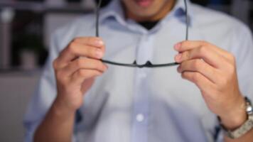 Exhausted Asian young businessman worker working on table in office. video