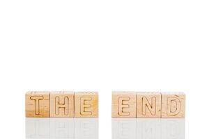 Wooden cubes with letters the end on a white background photo