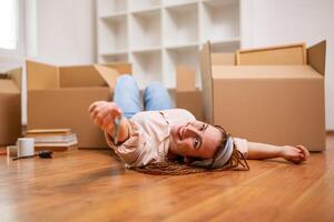 Happy ginger woman with braids holding key of her new home. photo