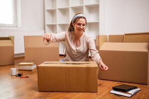 Modern ginger woman with braids moving into new home. photo