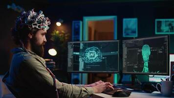 Developer with EEG headset on programming brain transfer into computer virtual world, becoming one with AI. Transhumanist using neuroscientific tech to transcend physical limitations, camera B video