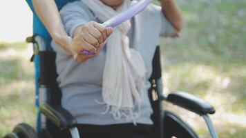 young asian physical therapist working with senior woman on walking with a walker video