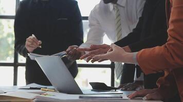 Close-up asia business people meeting plan analysis statistics brainstorm and header of team hold tablet pointing graph chart and employee take note. Finance strategy statistics success concept. video