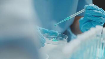 Doctor hand taking a blood sample tube from a rack with machines of analysis in the lab background, Technician holding blood tube test in the research laboratory. video