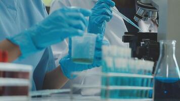 Doctor hand taking a blood sample tube from a rack with machines of analysis in the lab background, Technician holding blood tube test in the research laboratory. video