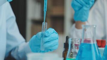 Doctor hand taking a blood sample tube from a rack with machines of analysis in the lab background, Technician holding blood tube test in the research laboratory. video