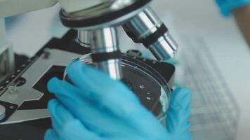 Doctor hand taking a blood sample tube from a rack with machines of analysis in the lab background, Technician holding blood tube test in the research laboratory. video