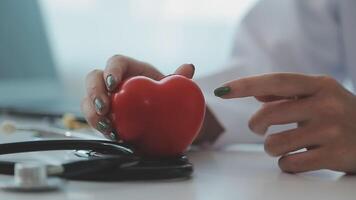 Cardiology consultation, treatment of heart disease. Doctor cardiologist while consultation showing anatomical model of human heart video