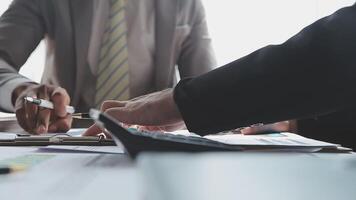 Business team collaboration discussing working analyzing with financial data and marketing growth report graph in team, presentation and brainstorming to strategy planning making profit of company. video