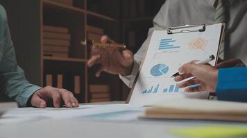 Business team collaboration discussing working analyzing with financial data and marketing growth report graph in team, presentation and brainstorming to strategy planning making profit of company. video