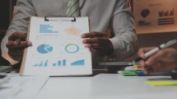 Business team collaboration discussing working analyzing with financial data and marketing growth report graph in team, presentation and brainstorming to strategy planning making profit of company. video