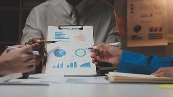 Business team collaboration discussing working analyzing with financial data and marketing growth report graph in team, presentation and brainstorming to strategy planning making profit of company. video