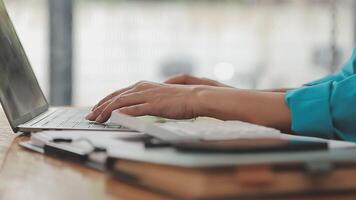 Asian Businesswoman Using laptop computer and working at office with calculator document on desk, doing planning analyzing the financial report, business plan investment, finance analysis concept. video