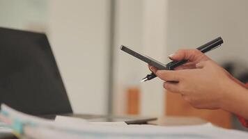 Asian Businesswoman Using laptop computer and working at office with calculator document on desk, doing planning analyzing the financial report, business plan investment, finance analysis concept. video
