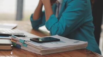 Asian Businesswoman Using laptop computer and working at office with calculator document on desk, doing planning analyzing the financial report, business plan investment, finance analysis concept. video