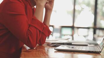 Asian Businesswoman Using laptop computer and working at office with calculator document on desk, doing planning analyzing the financial report, business plan investment, finance analysis concept. video