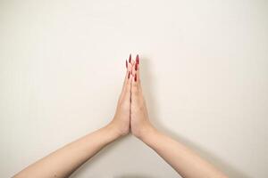 Hand use nails art pointing at something and make a sign on white background photo