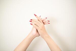 Hand use nails art pointing at something and make a sign on white background photo