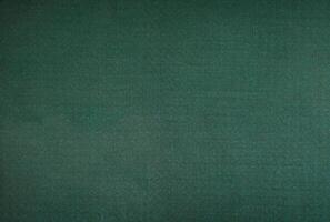abstract festive background of dark fabric and green photo