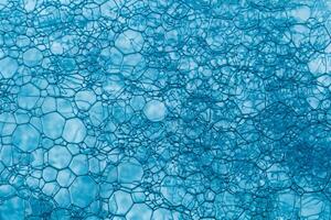 Blue Soap Bubbles, Abstract Macro Foam Background, Closeup Texture of Soap Foam photo