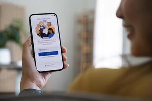 A working from home employee is downloading the Microsoft Teams social platform, ready for remote working in isolation from home photo