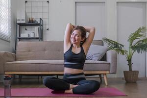 young asian beauty woman doing yoga at home photo