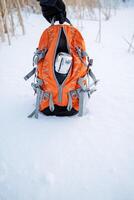 Backpack close-up. Camping equipment. Pack up for a winter hike. Take a thermos in your bag. Winter trip. photo